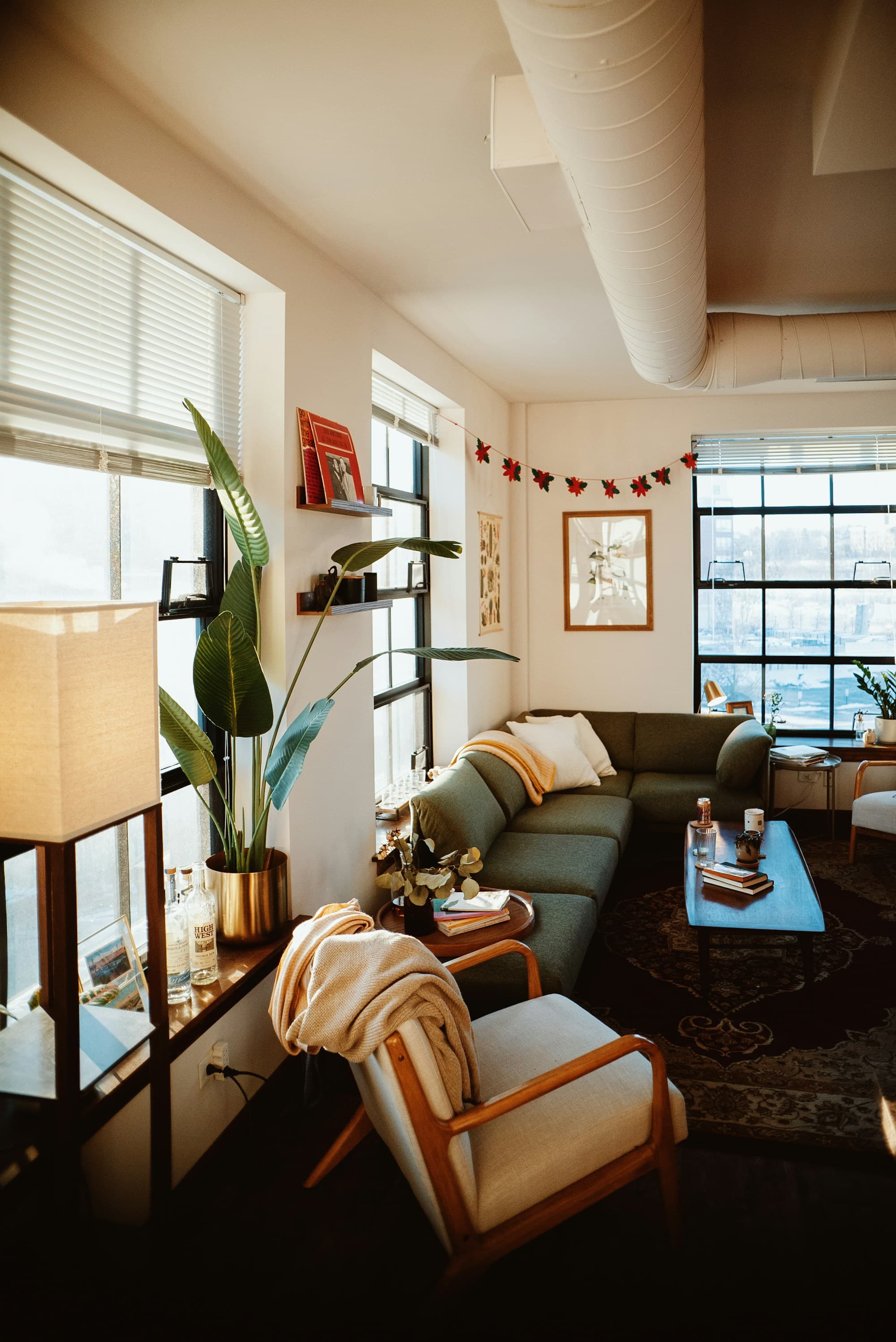 Modern open-plan apartment living space with natural light and outdoor area — the reward of well-managed strata living